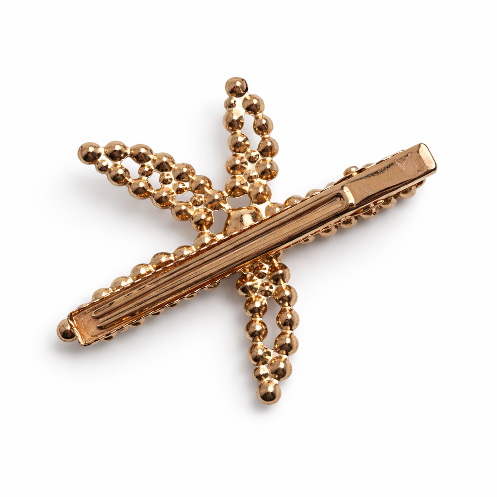 Gold tie clip with beaded design on a white background