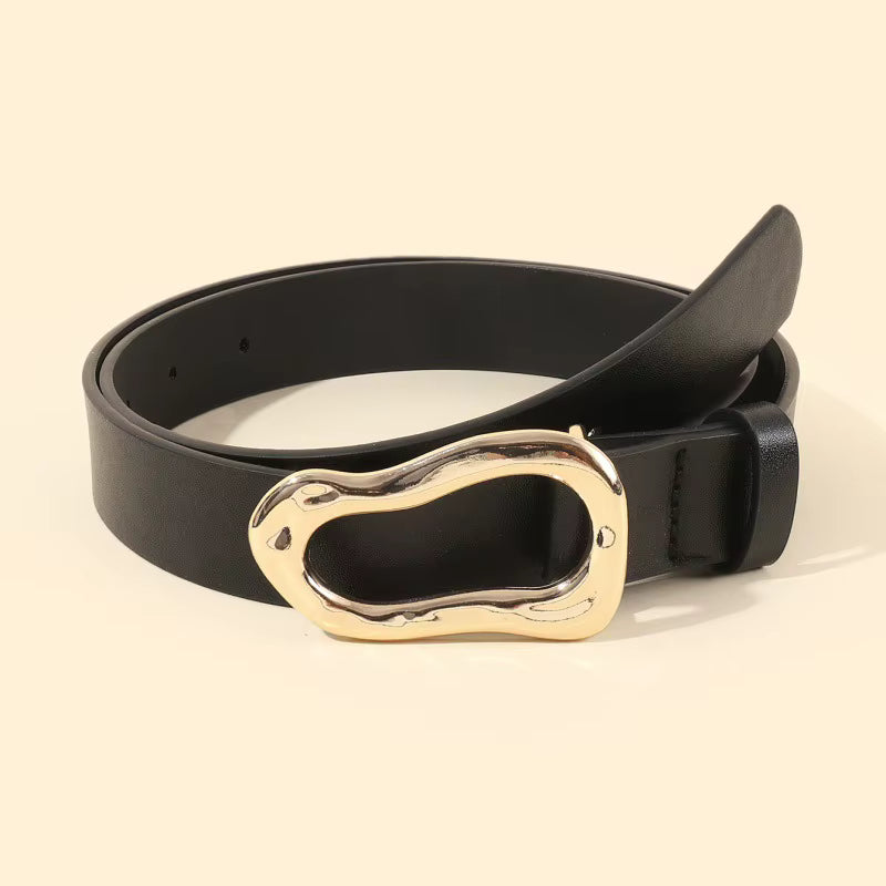 Black belt with a gold buckle on a beige background