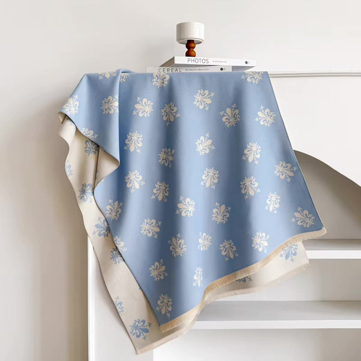 Blue and beige patterned fabric draped over a white surface