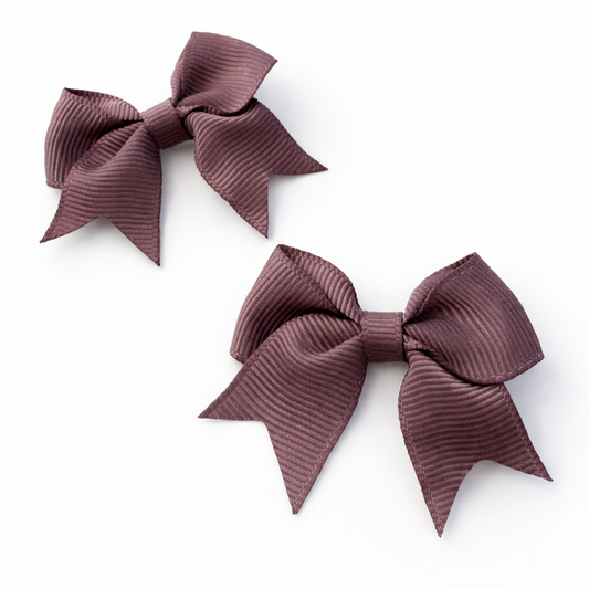 Two brown hair bows on a white background