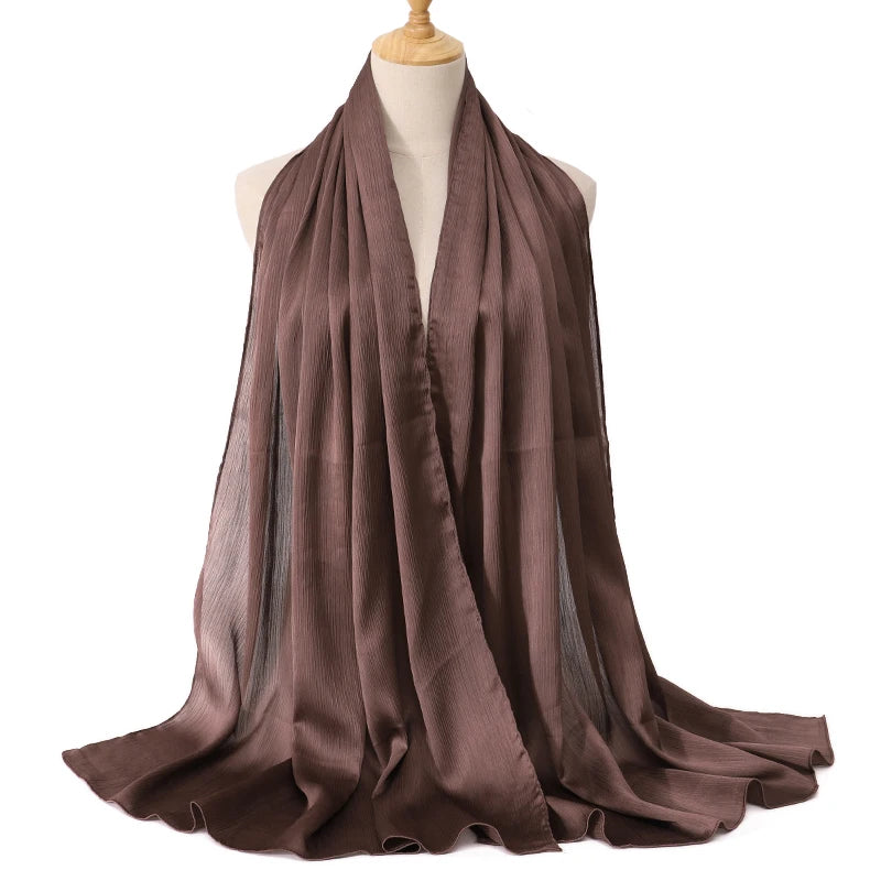 Brown scarf on a mannequin with a white background