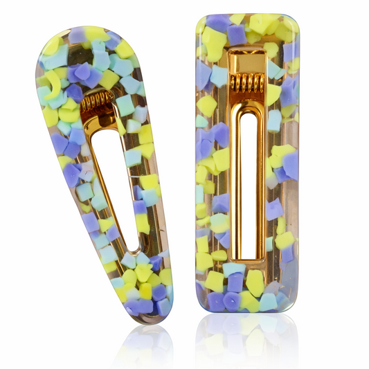 Colorful hair clips with gold accents on a white background
