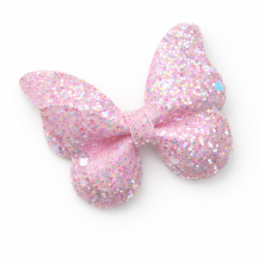 Pink glittery bow on a white background