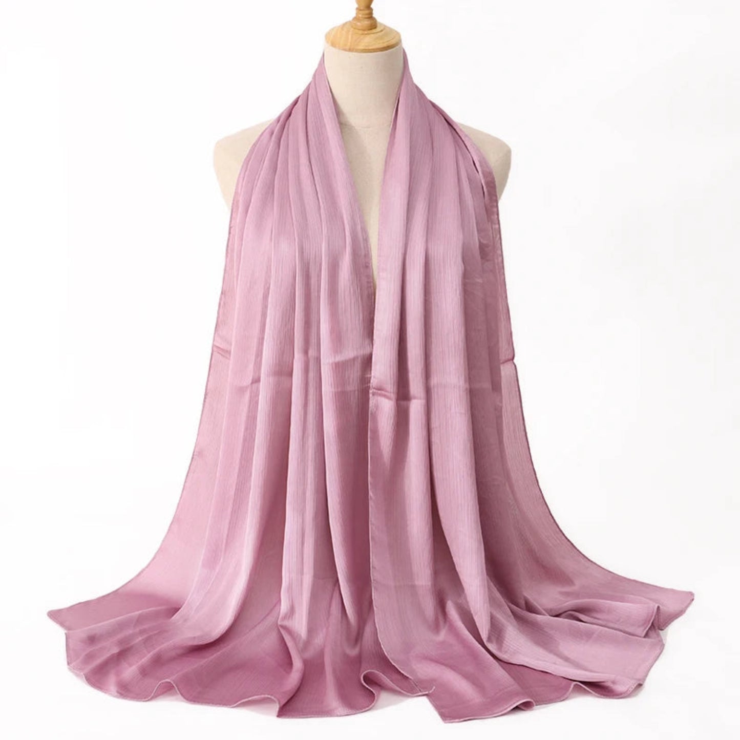 Pink scarf on a mannequin against a white background