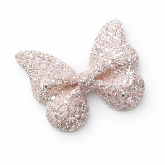 Rose gold glittery bow on a white background
