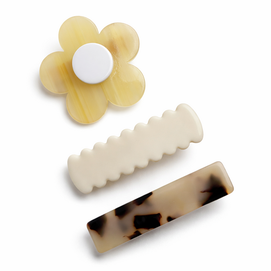 Set of three hair clips with a flower-shaped clip on a white background