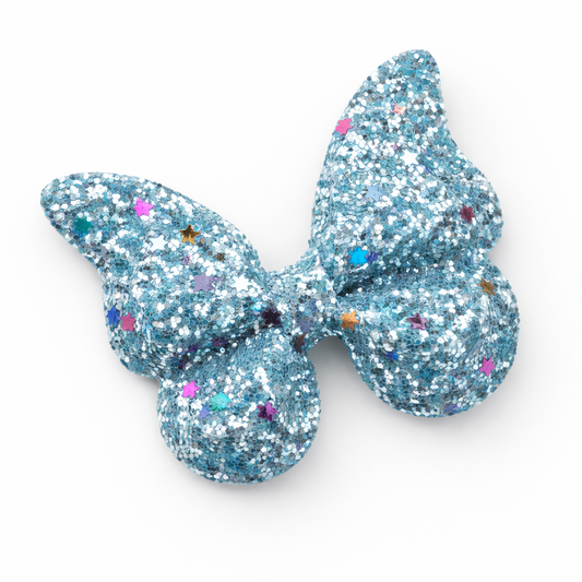 Blue glitter butterfly hair clip on a white background
