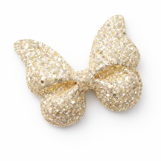 Gold glittery bow on a white background