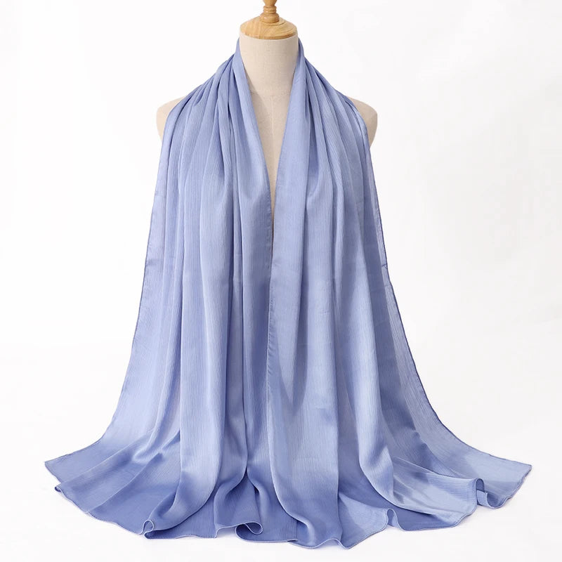 Light blue scarf on a mannequin against a white background