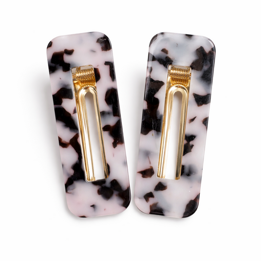 Pair of marbled rectangular earrings with gold bars on a white background