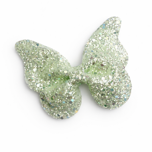 Glittery butterfly-shaped hair clip on a white background