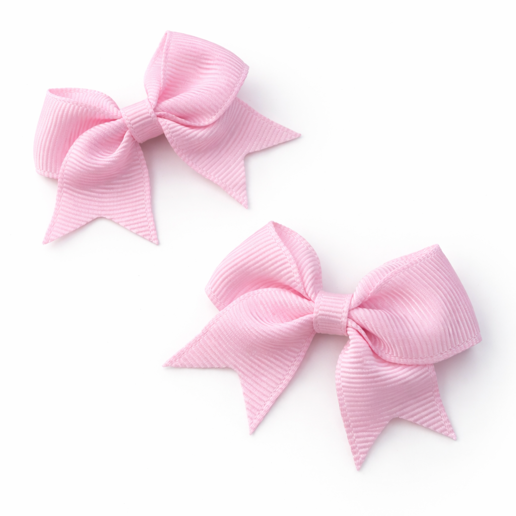 Two pink hair bows on a white background
