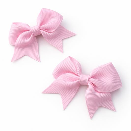 Two pink hair bows on a white background
