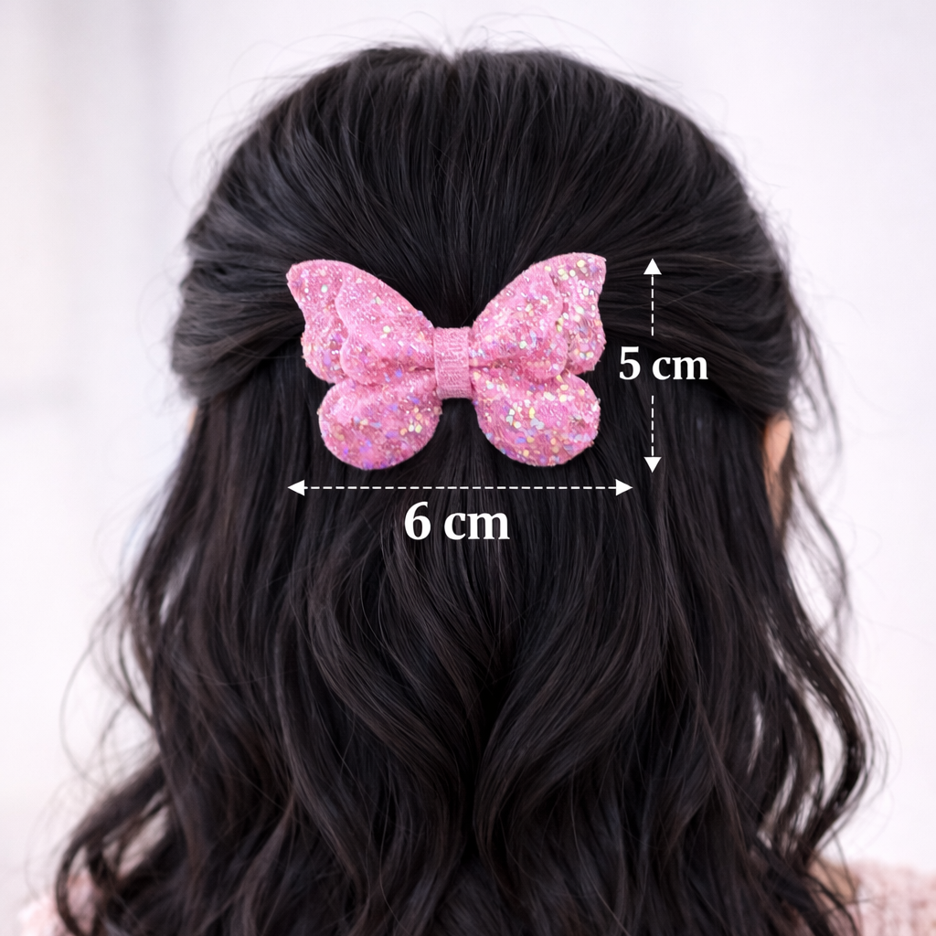 Black hair with a pink bow measuring 6 cm by 5 cm on a white background