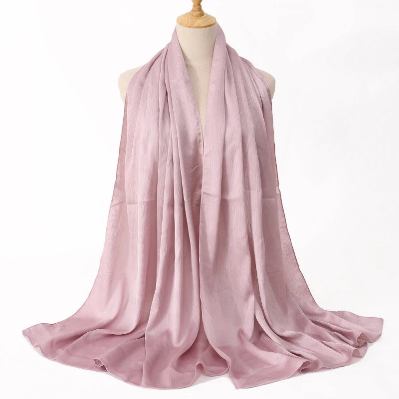 Pink scarf on a mannequin against a white background