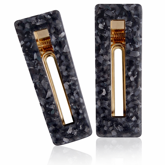 Pair of earrings with black marbled design and gold accents on a white background