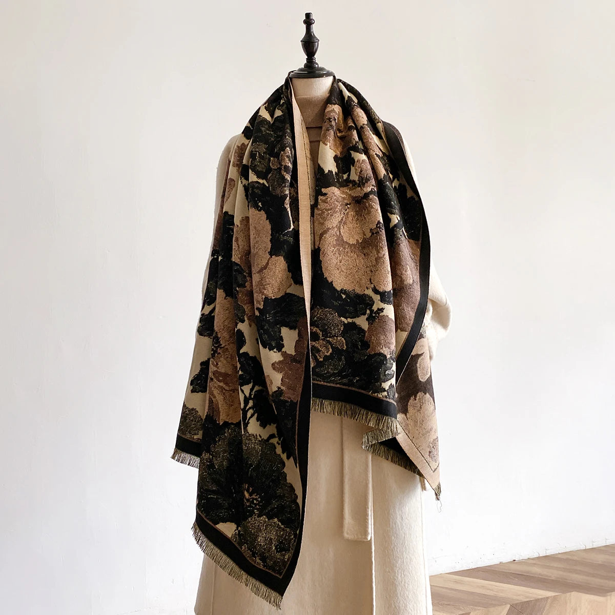 Floral patterned scarf draped over a mannequin against a neutral background