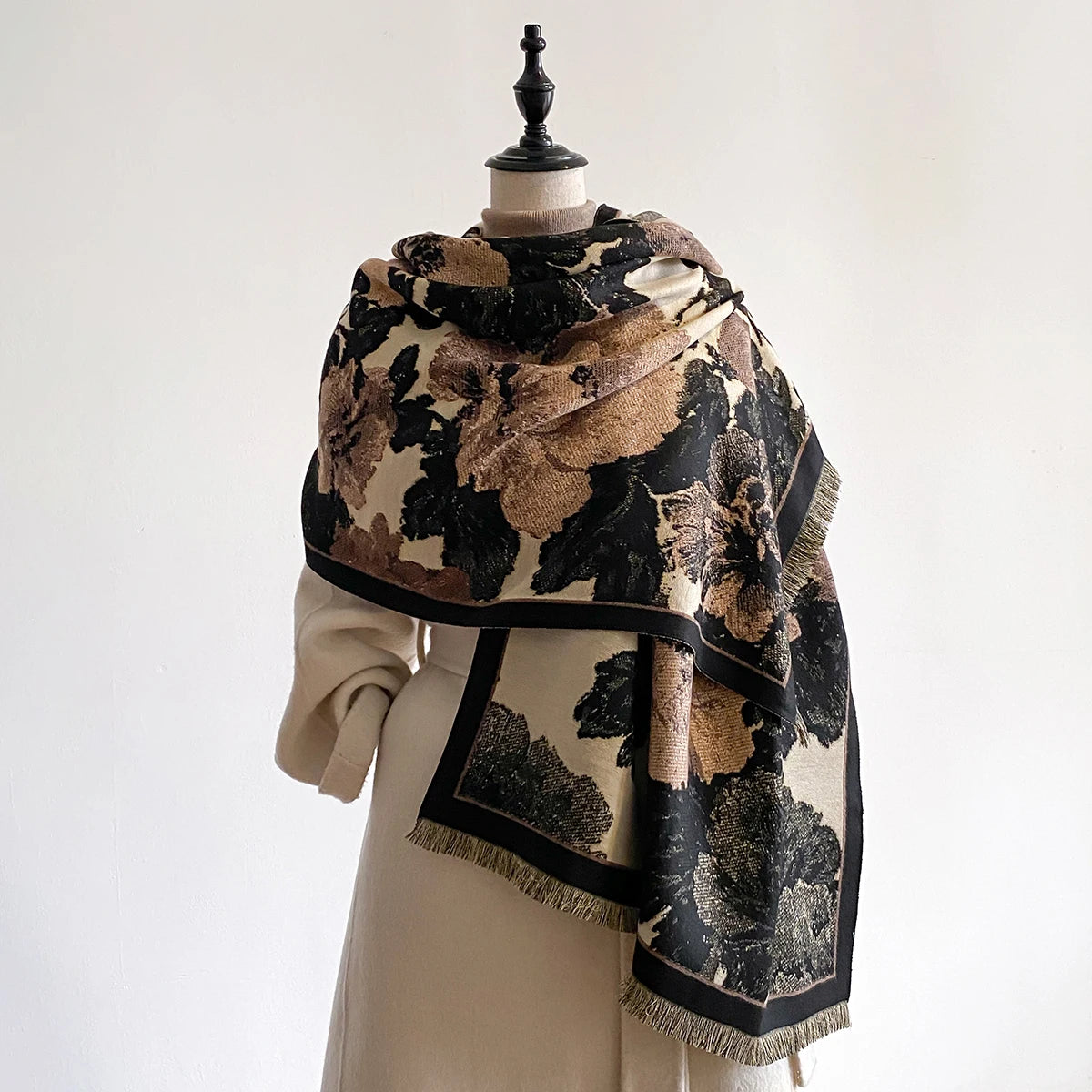 Mannequin wearing a floral patterned scarf with a neutral background