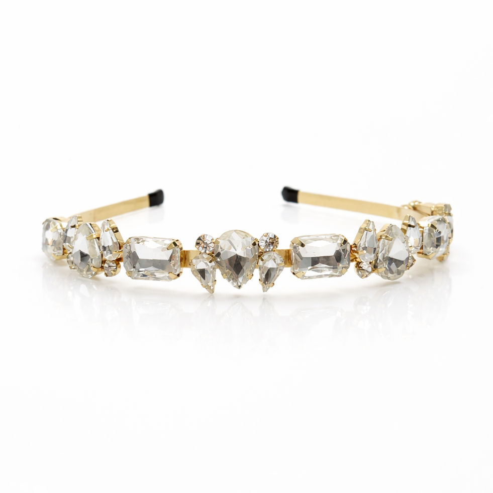 Gold headband with clear gemstones on a white background