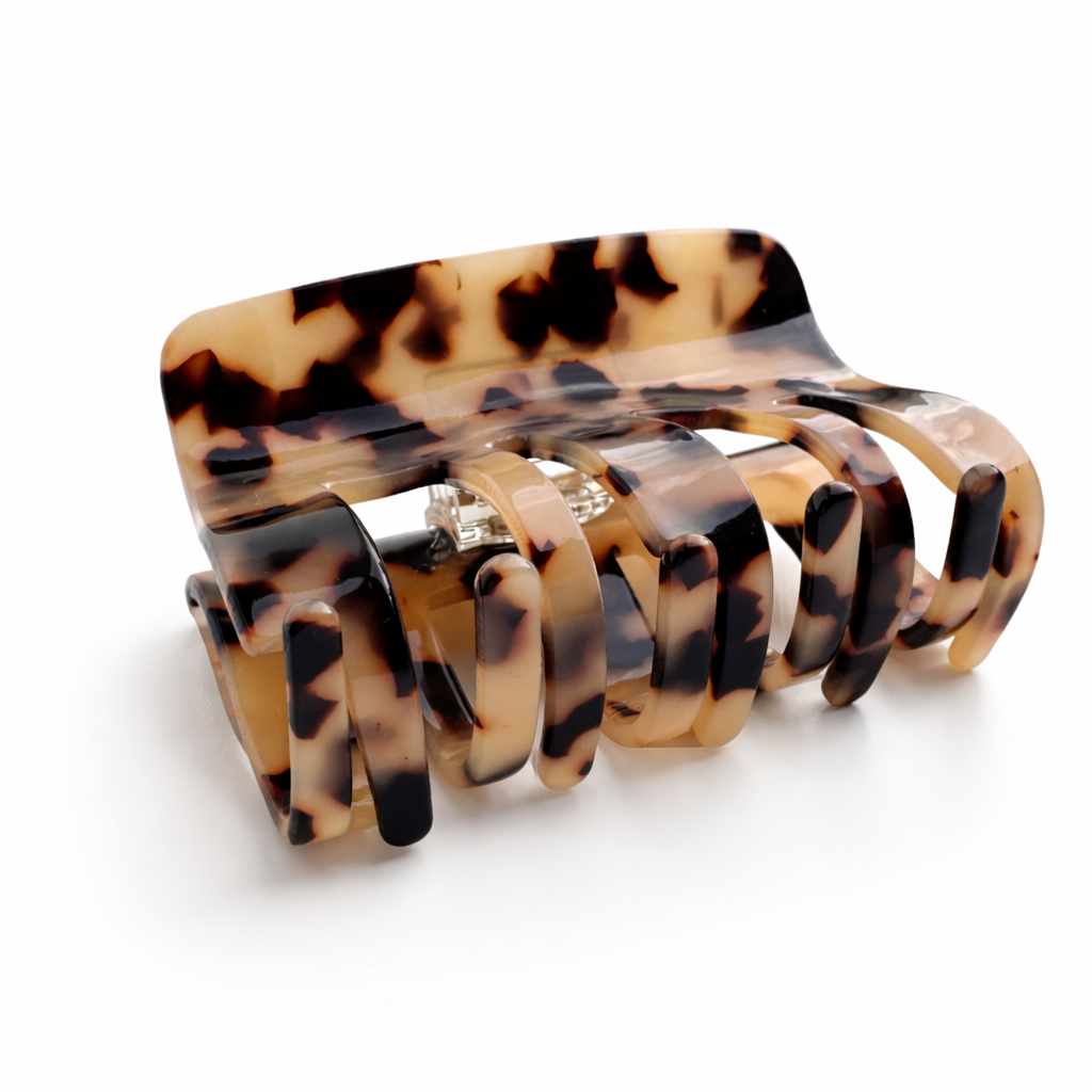 Tortoiseshell patterned hair clip on a white background