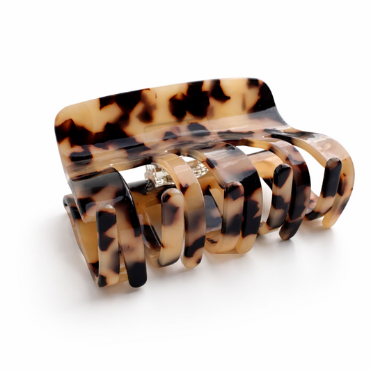 Tortoiseshell patterned hair clip on a white background