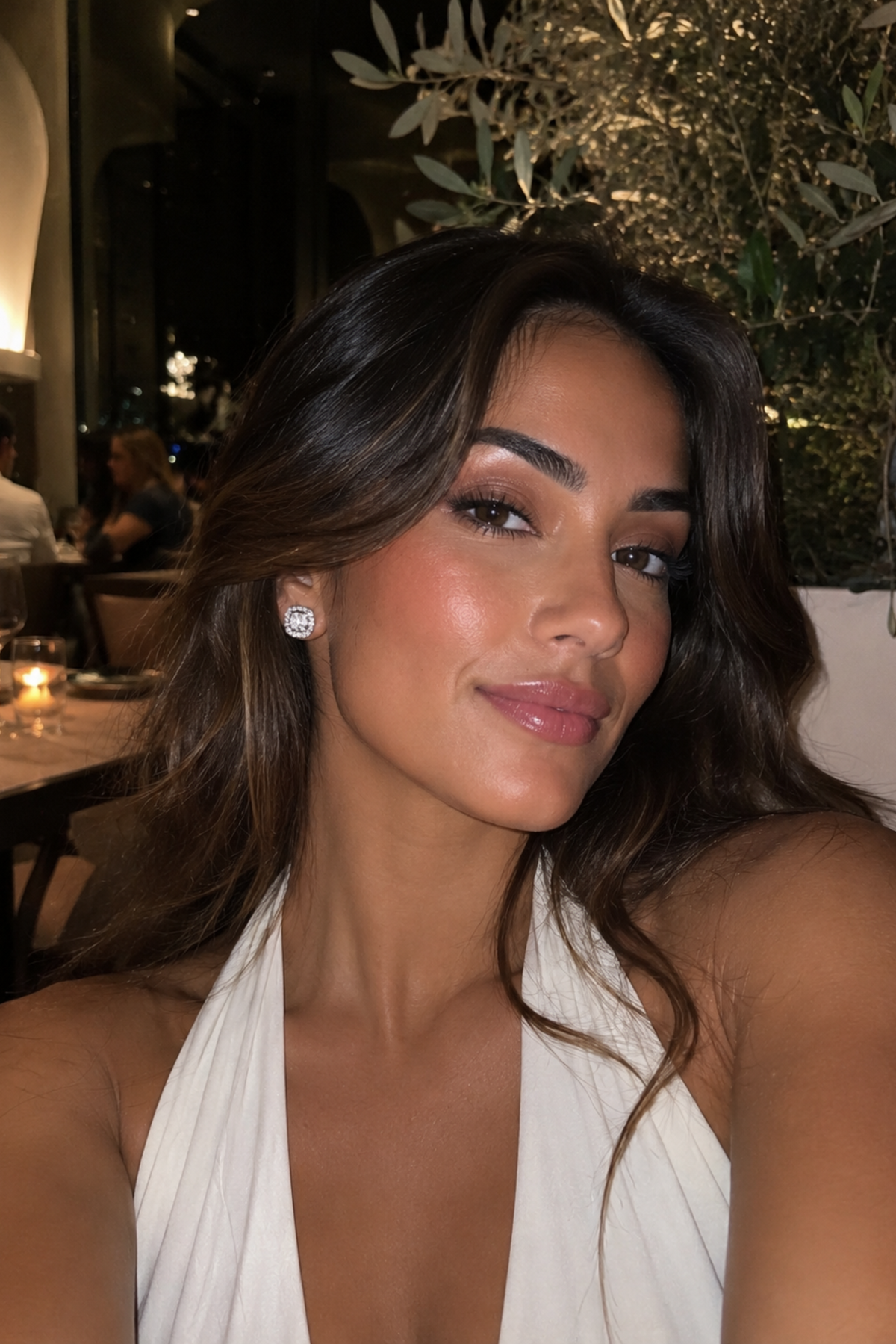 Woman in a white dress sitting outdoors at night