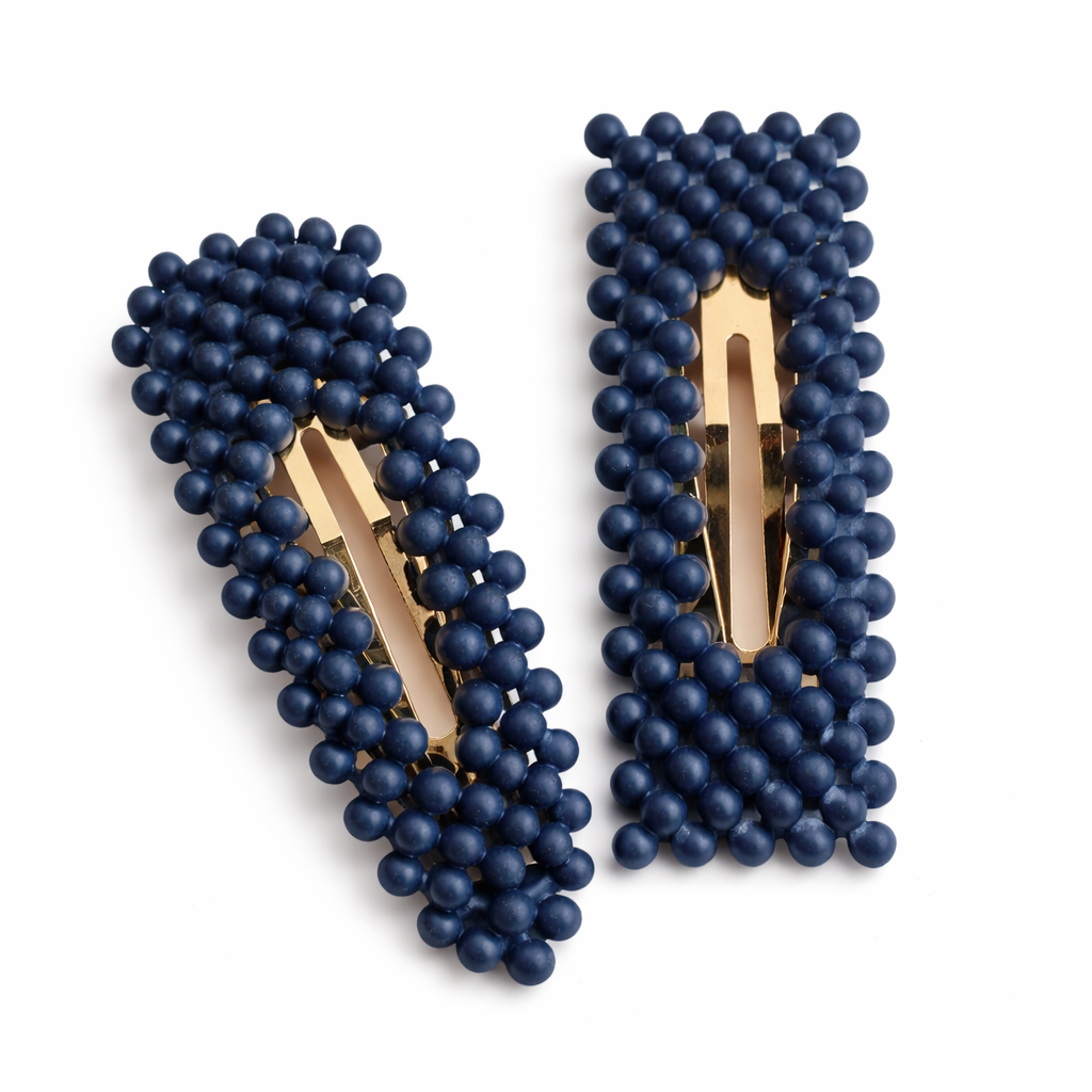 Pair of navy blue beaded earrings with gold clips on a white background