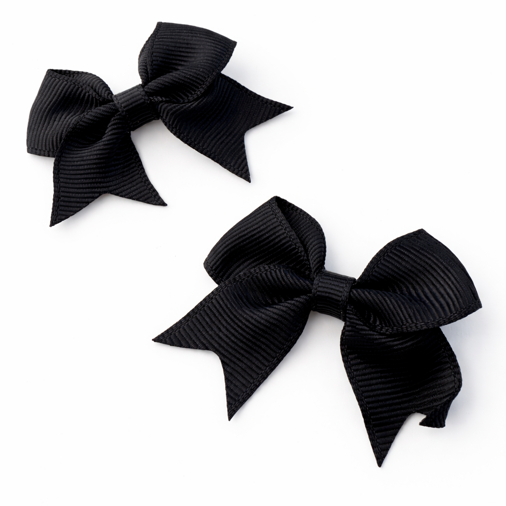 Two black hair bows on a white background