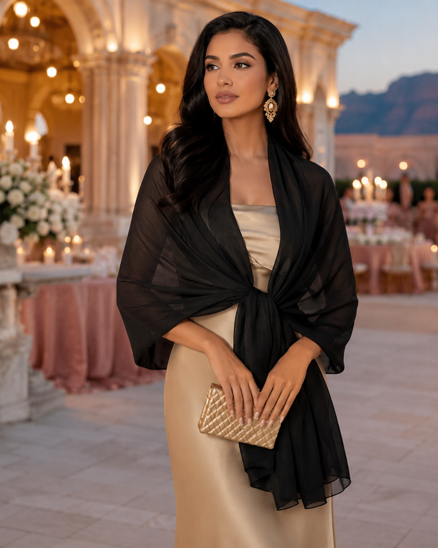 Woman in elegant outfit with black shawl and gold clutch in a luxurious setting