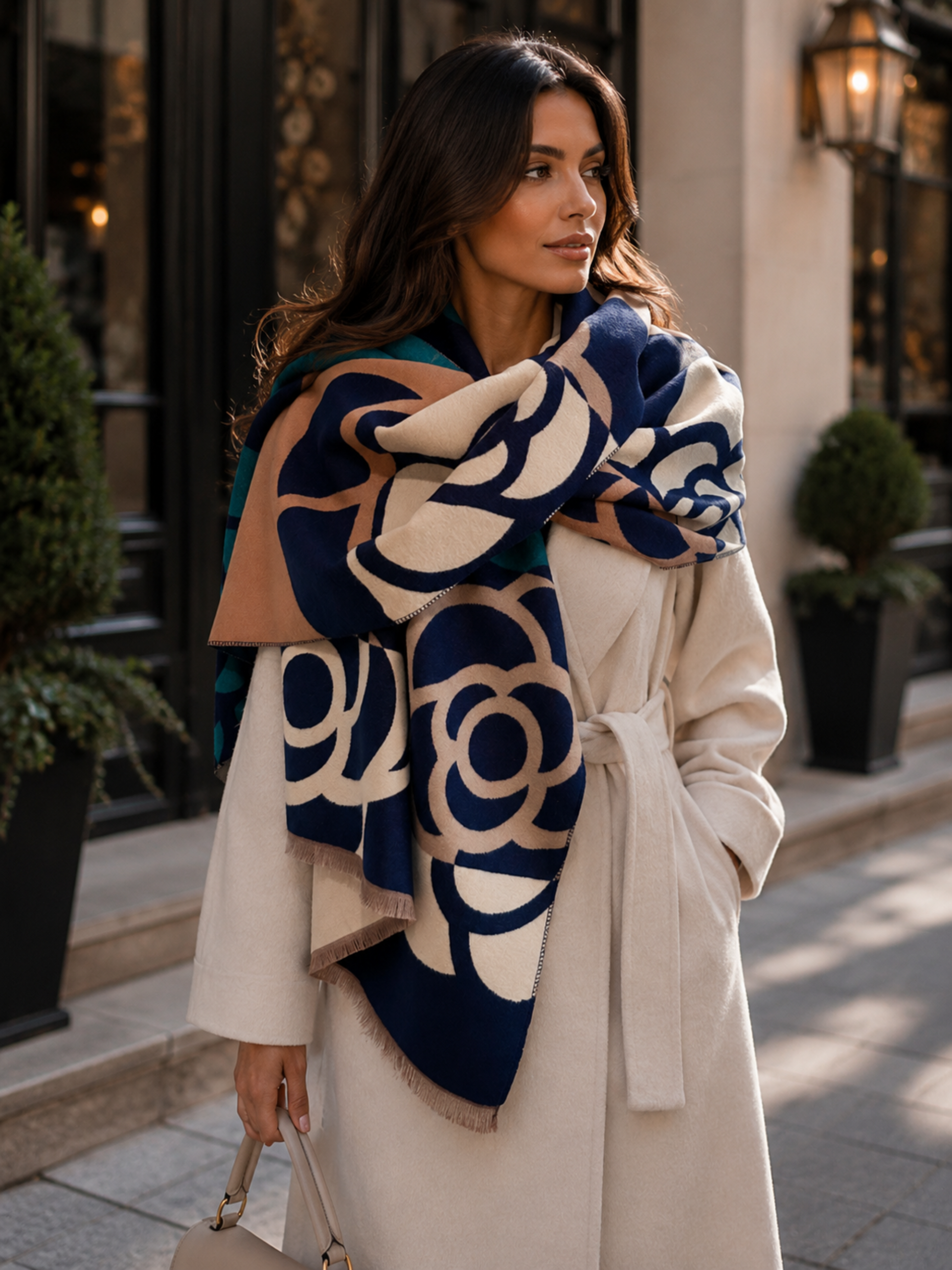 Woman wearing a patterned scarf and coat on a city street