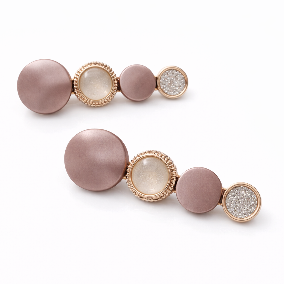 Pair of earrings with pink and gold design on a white background