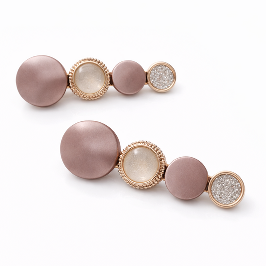 Pair of earrings with pink and gold design on a white background