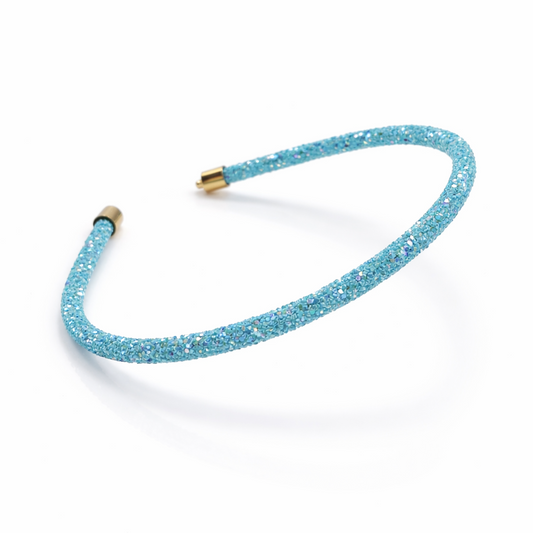 Blue glittery headband with gold ends on a white background