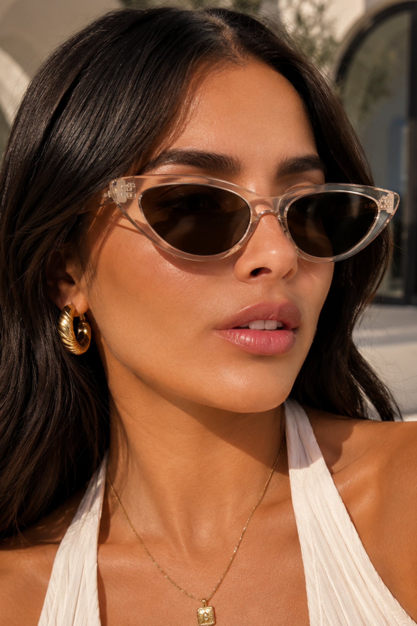 Woman wearing sunglasses with a neutral background