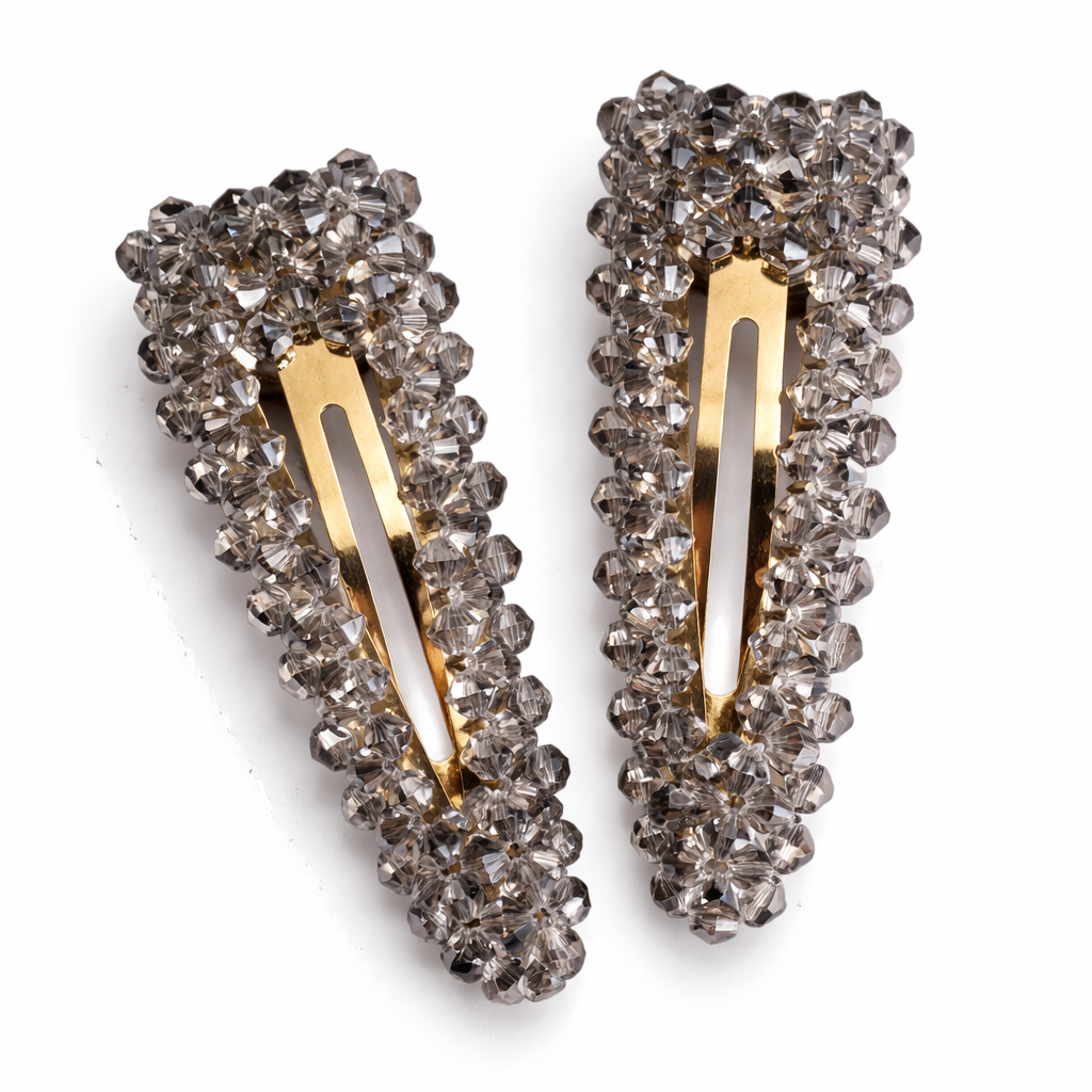 Pair of decorative hair clips with crystal embellishments on a white background