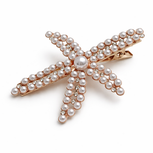 Starfish-shaped hair clip with pearls on a white background