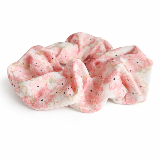 Pink and white patterned scrunchie on a white background