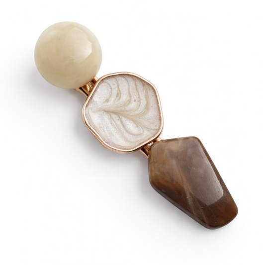 Earring with a combination of beige, brown, and rose gold elements on a white background