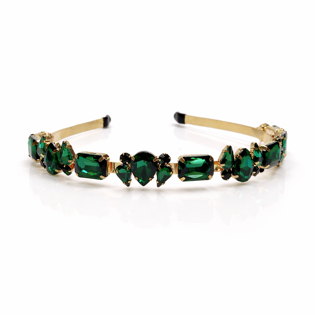 Gold headband with green gemstones on a white background