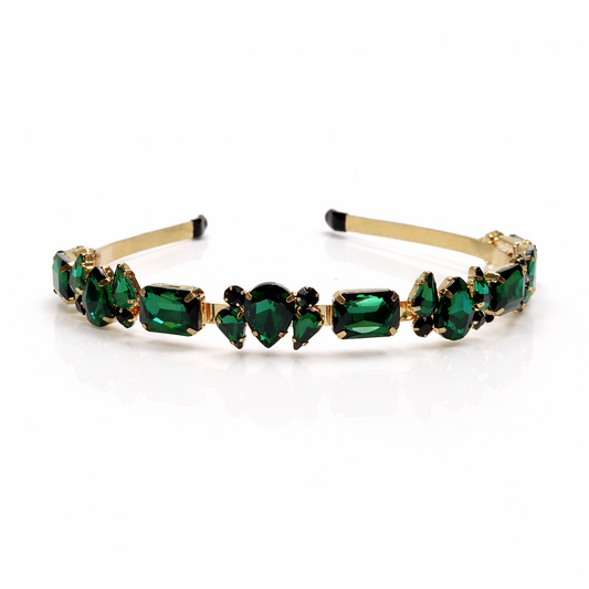 Gold headband with green gemstones on a white background