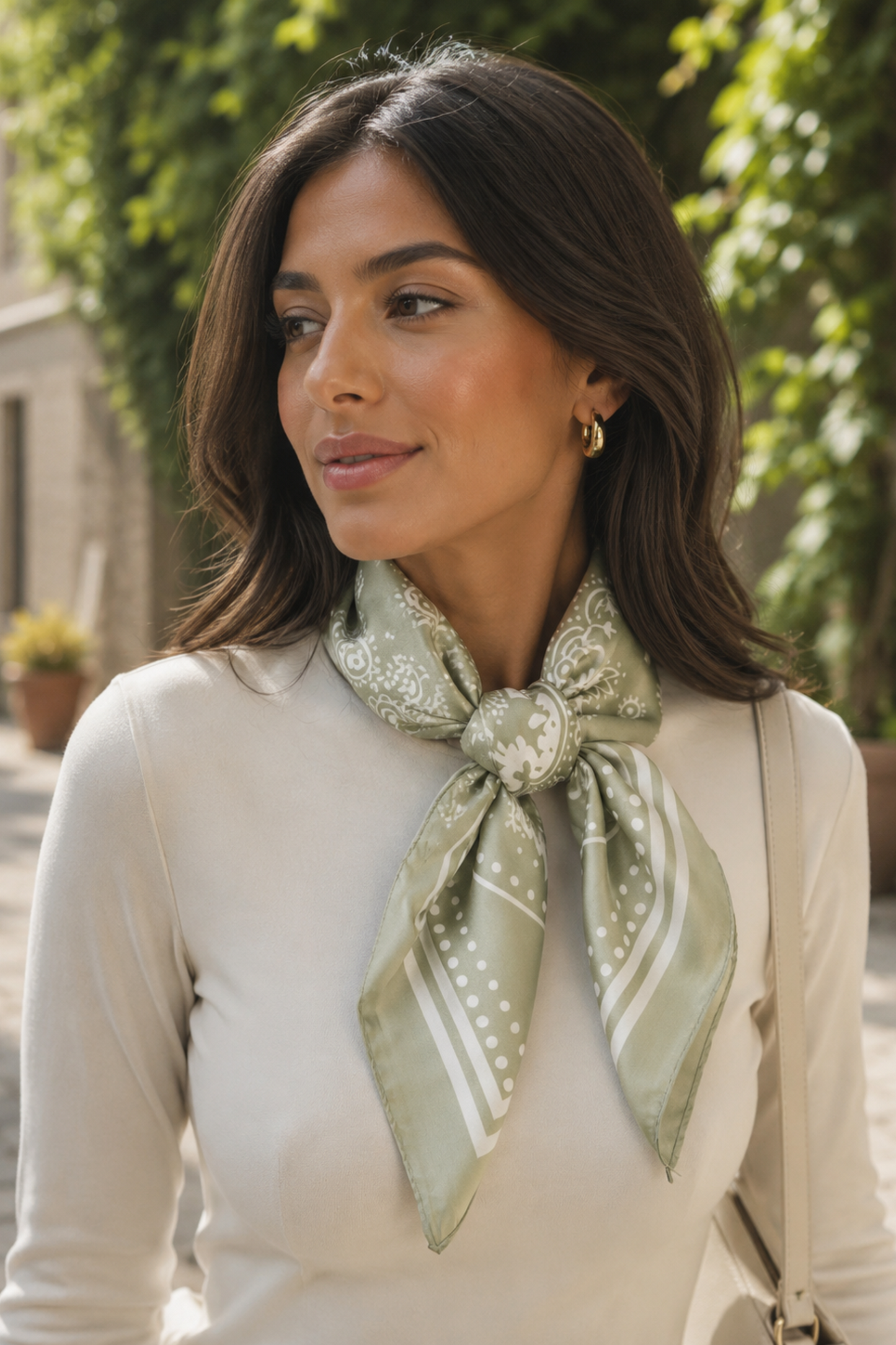 Woman wearing a green patterned scarf outdoors