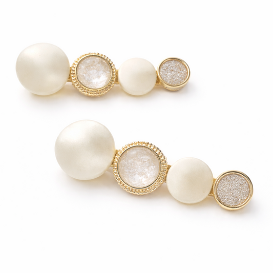 Pair of earrings with pearls and gold accents on a white background