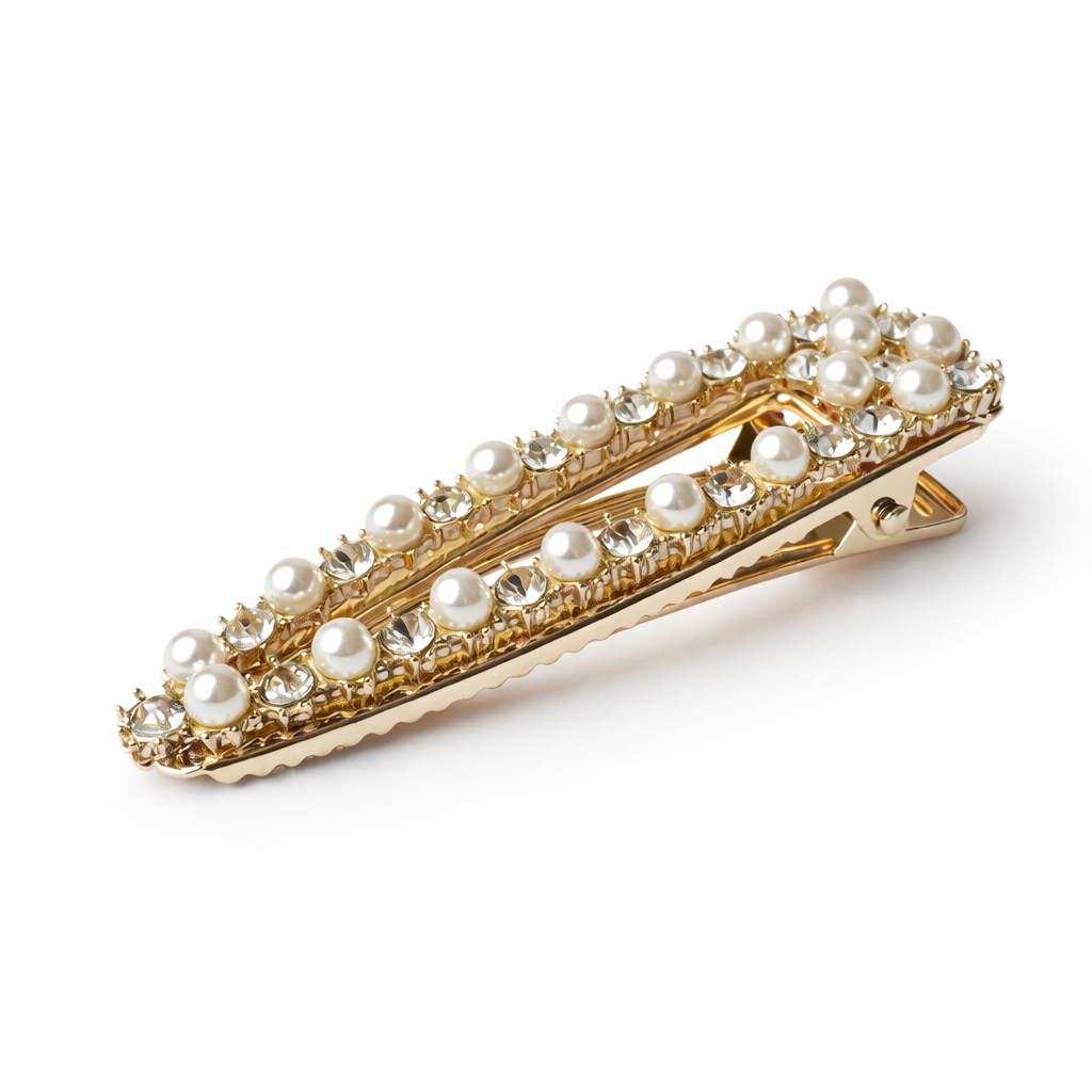 Gold hair clip with pearls on a white background