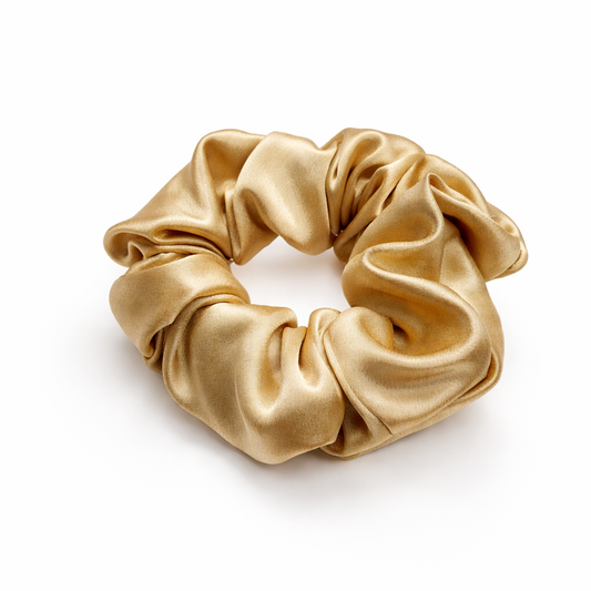 Gold scrunchie on a white background