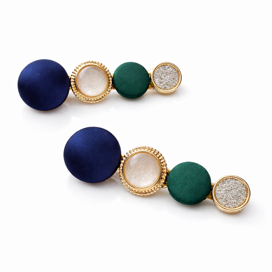Set of hair clips with blue, green, and gold colors on a white background