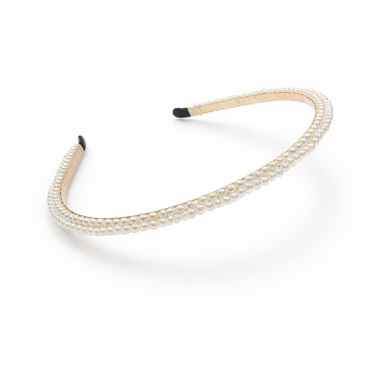Beige headband with black ends on a white background
