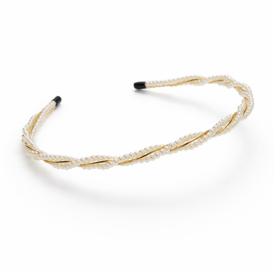 Gold headband with black ends on a white background