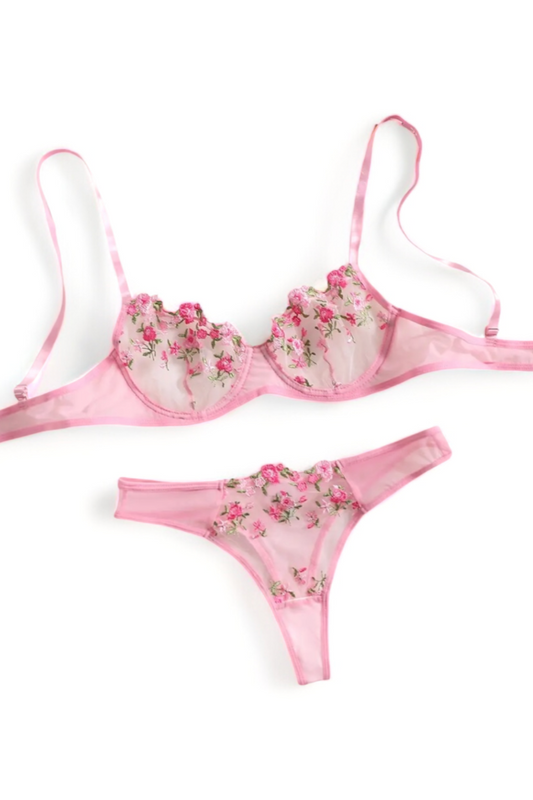Flat lay of a pink floral lingerie set including lace bra and matching panties, stylish women’s intimate apparel.