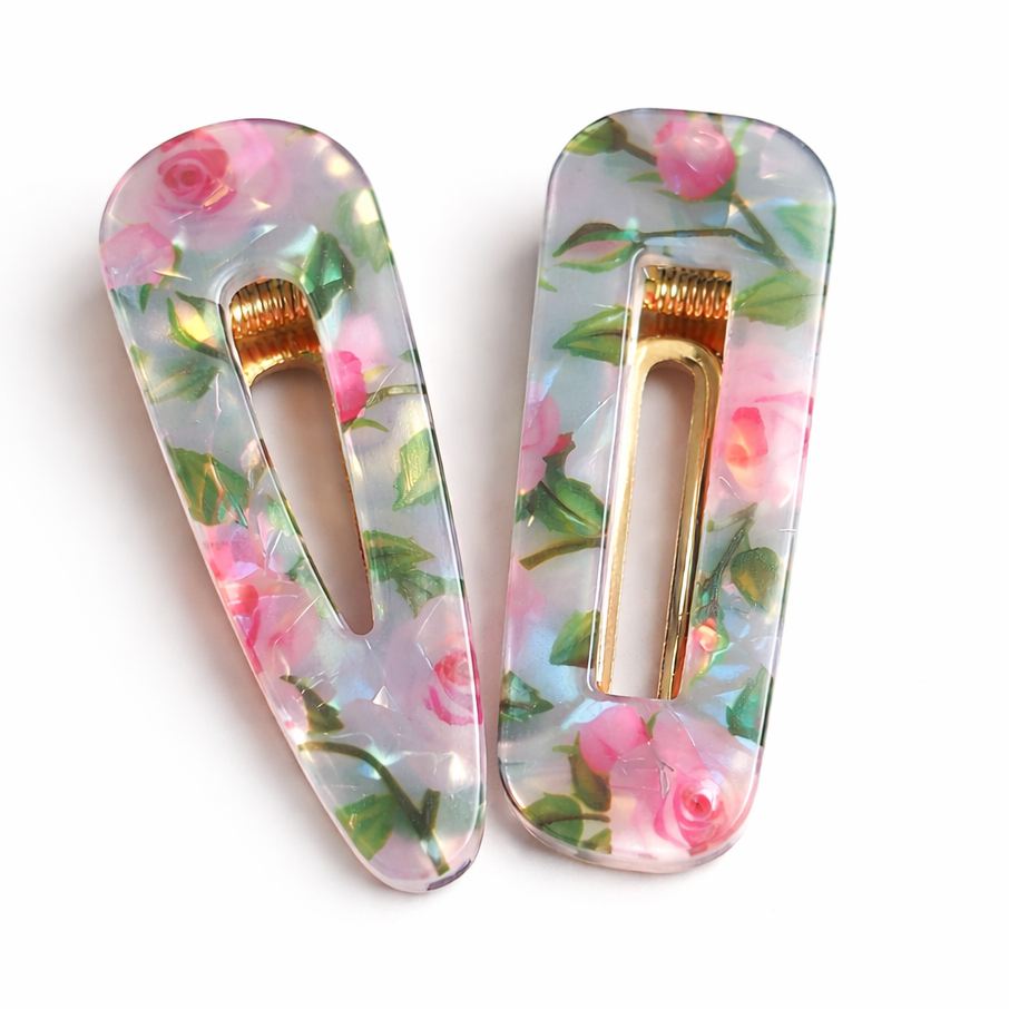 Pink rose resin hair clip with gold snap barrette photographed on a clean white background