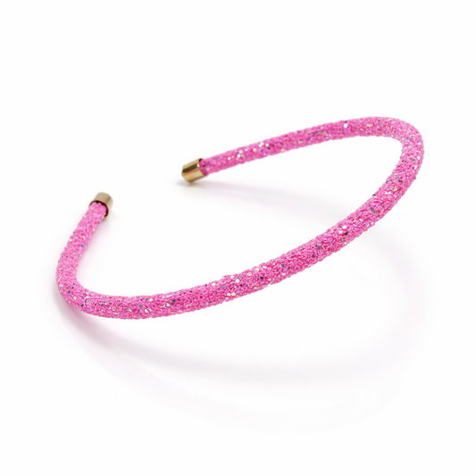 Pink glittery headband on a white background